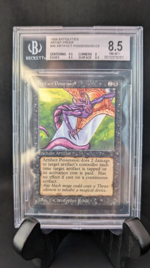 A professionally graded Magic: The Gathering card, Artifact Possession from the 1994 Antiquities set, encased in a clear Beckett acrylic slab and graded 8.5. The label displays subgrades for centering, corners, edges, and surface, and the card features artwork by Christopher Rush with a vibrant purple creature on a glowing background.