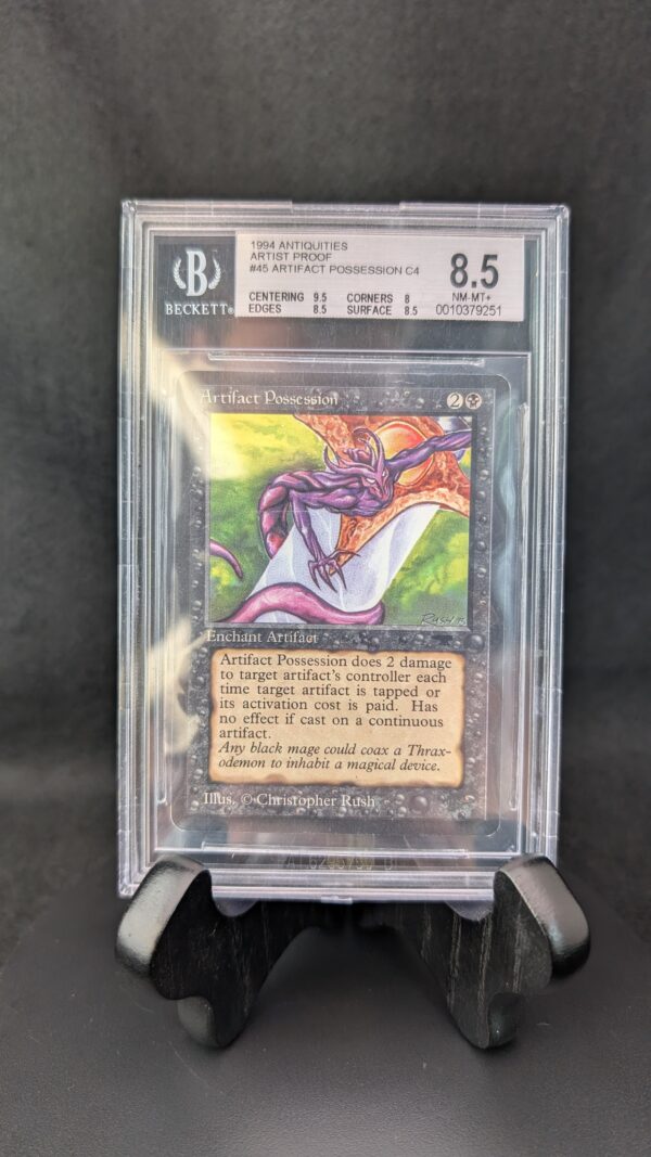 A professionally graded Magic: The Gathering card, Artifact Possession from the 1994 Antiquities set, encased in a clear Beckett acrylic slab and graded 8.5. The label displays subgrades for centering, corners, edges, and surface, and the card features artwork by Christopher Rush with a vibrant purple creature on a glowing background.