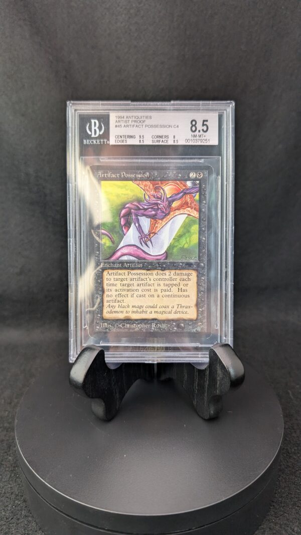 A professionally graded Magic: The Gathering card, Artifact Possession from the 1994 Antiquities set, encased in a clear Beckett acrylic slab and graded 8.5. The label displays subgrades for centering, corners, edges, and surface, and the card features artwork by Christopher Rush with a vibrant purple creature on a glowing background.